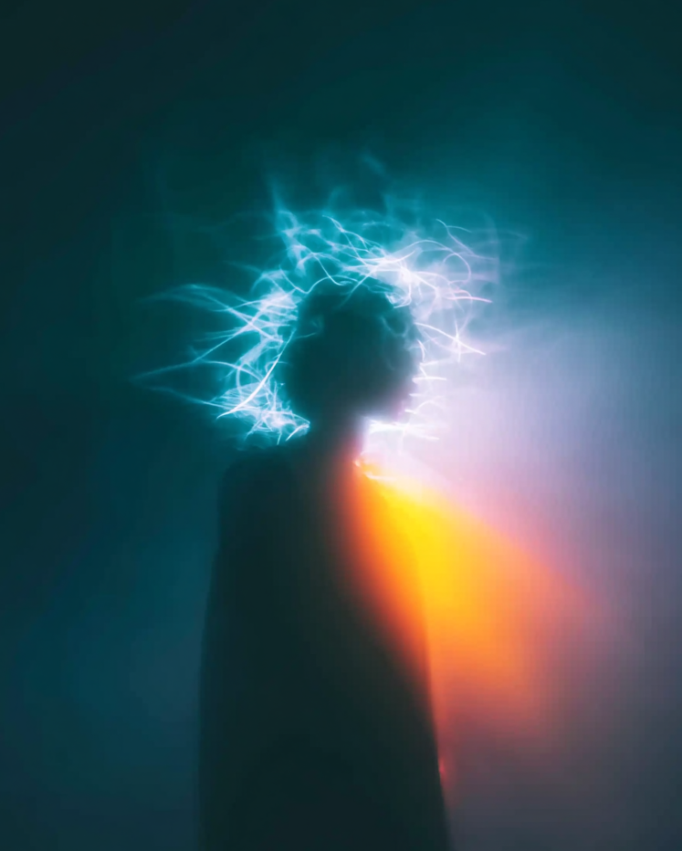 Silhouette of a person with electric-like effects in a dark setting