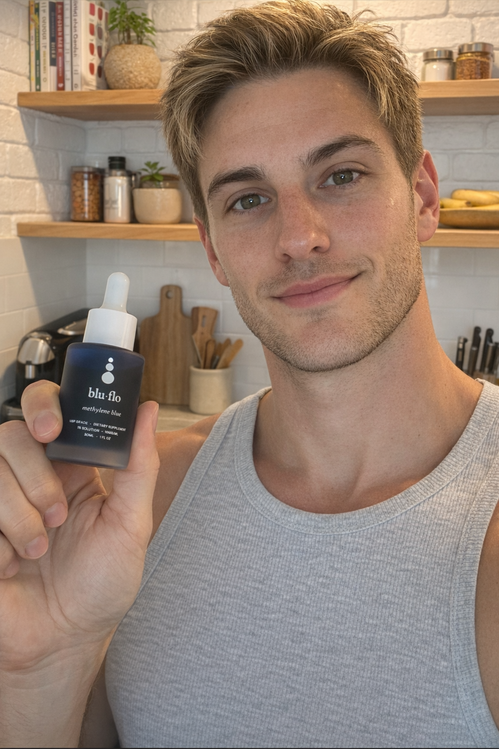 Man holding a blu flo dropper bottle of methylene blue in a kitchen setting